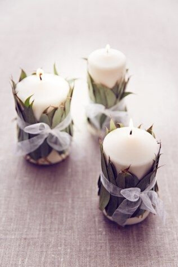 DIY Wedding Decorations like these eucalyptus wrapped candles make the perfect budget centerpiece at your reception