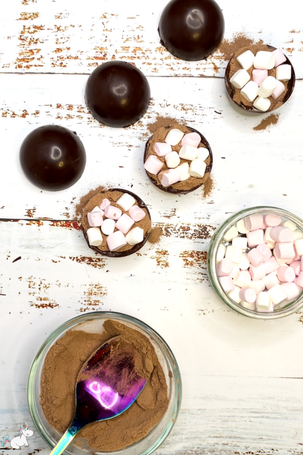 Fill the halves you used in the last step with 1 heaped teaspoon of hot chocolate powder and mini marshmallows. Don't over fill them as you'll have difficulty closing them in the next step.