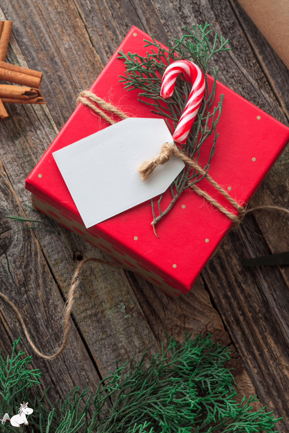 A handmade gift wrapped up and embellished with a candy cane