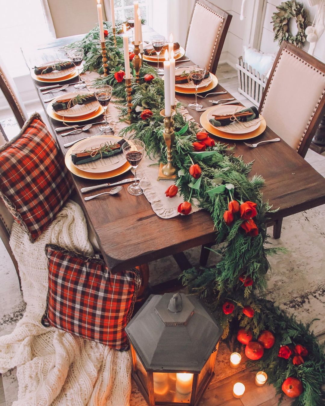 Red flowers and green garlands are one of the most popular tabletop Christmas decor ideas