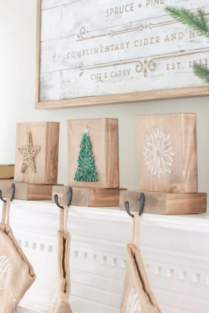 HAndmade wooden blocks decorated with festive string designs and hooks to hold stockings