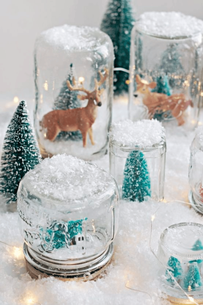 Reindeer in a snowy forest scene dry snow globe