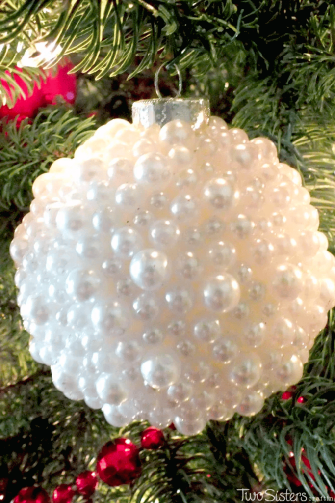 Handmade pearl bauble hanging from tree