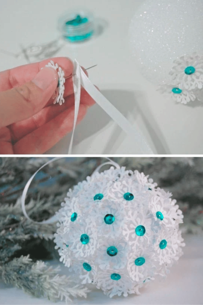 Bauble covered with white paper punched snowflakes