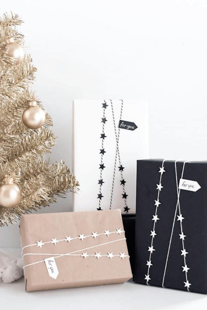three presents wrapped with mini star garlands