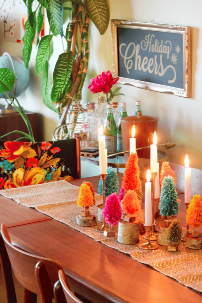 Festive table decorated with candles and colorful yarn trees