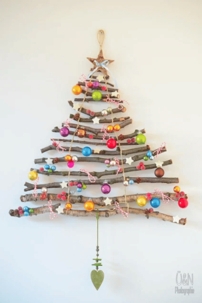 Christmas tree made with twigs and decorated with colourful ornaments