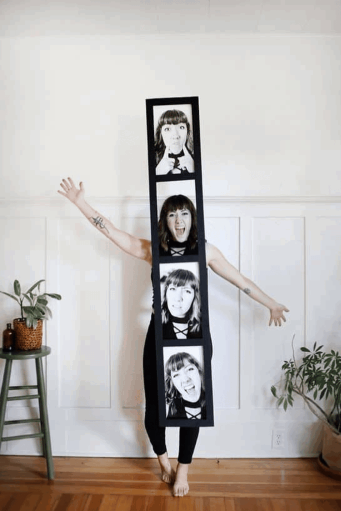 Woman dressed as a photo booth strip with four black-and-white selfie frames displayed down the front of her outfit.