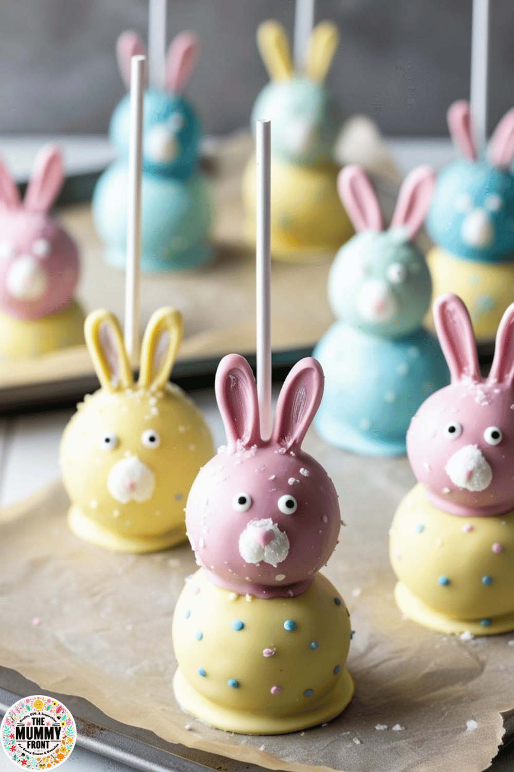 Pastel-colored bunny cake pops with candy ears, wide eyes, and sweet frosting accents.
