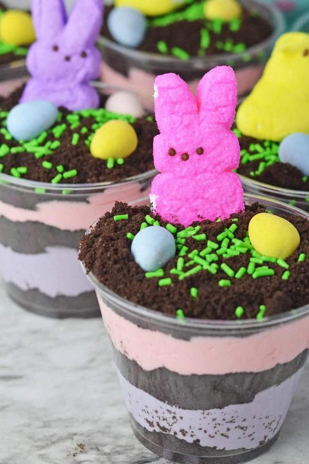 Clear dessert cups layered with chocolate pudding, cookie crumbs, marshmallow bunnies, and candy eggs.