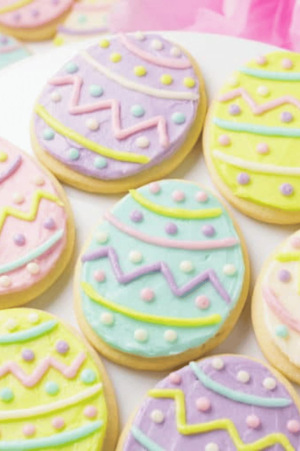 Easter egg-shaped sugar cookies decorated with pastel icing and zigzag patterns