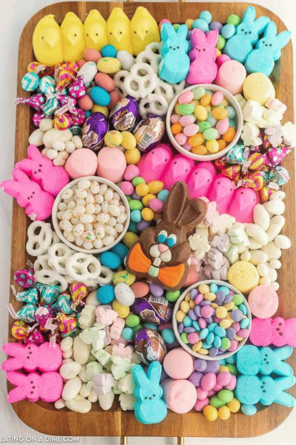 A candy charcuterie board with pastel Easter treats, including Peeps, jelly beans, and chocolates.