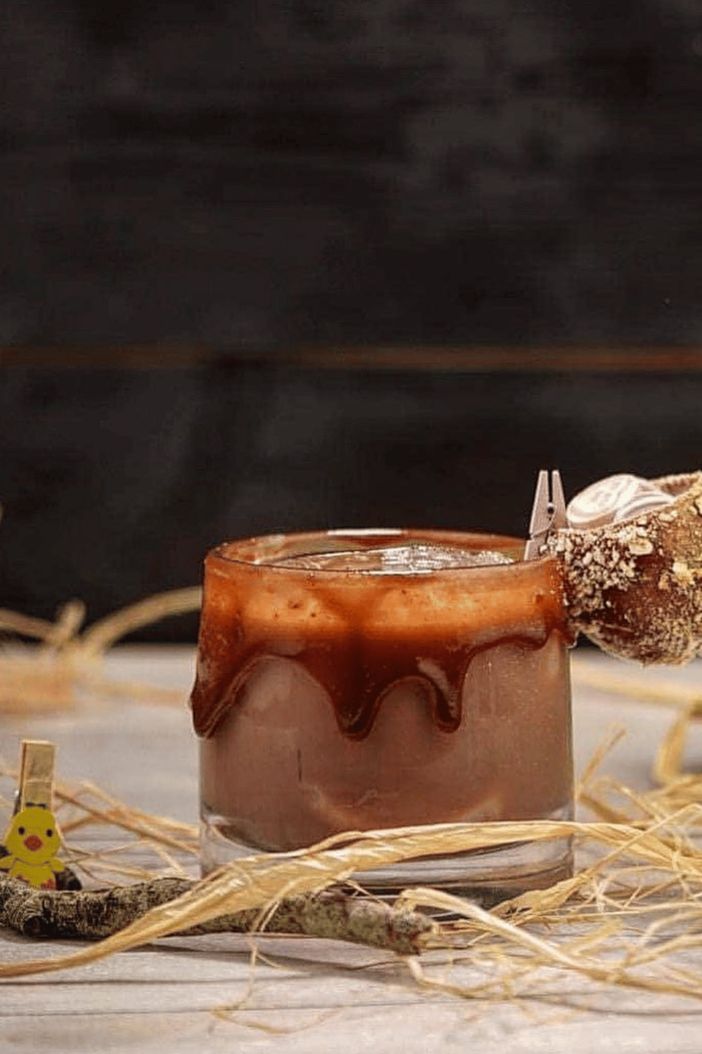 A chocolate mudslide cocktail topped with chocolate drizzle and Easter-themed decorations.