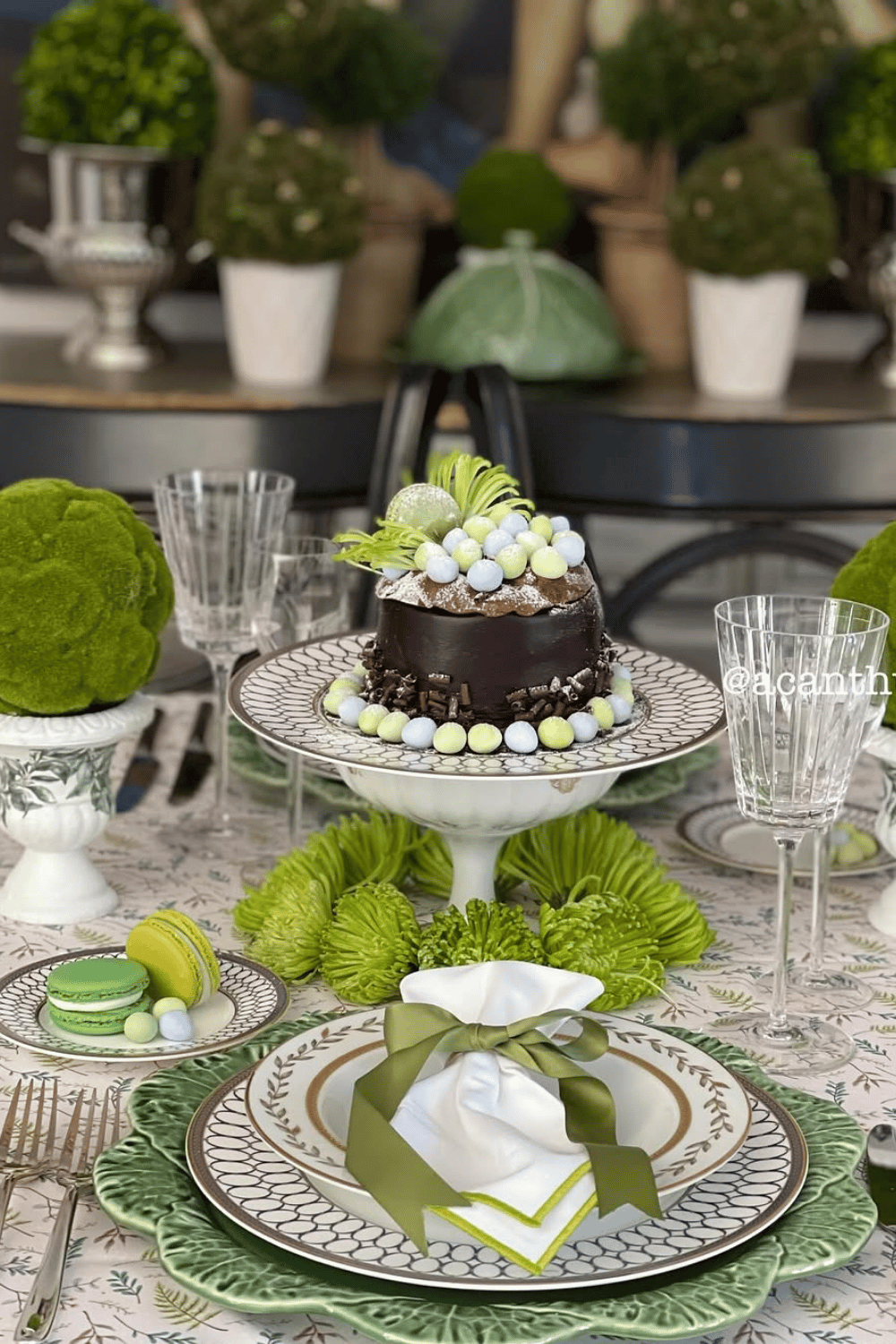 Decadent chocolate and greenery Easter table ideas featuring a delicious cake and mossy centerpiece.