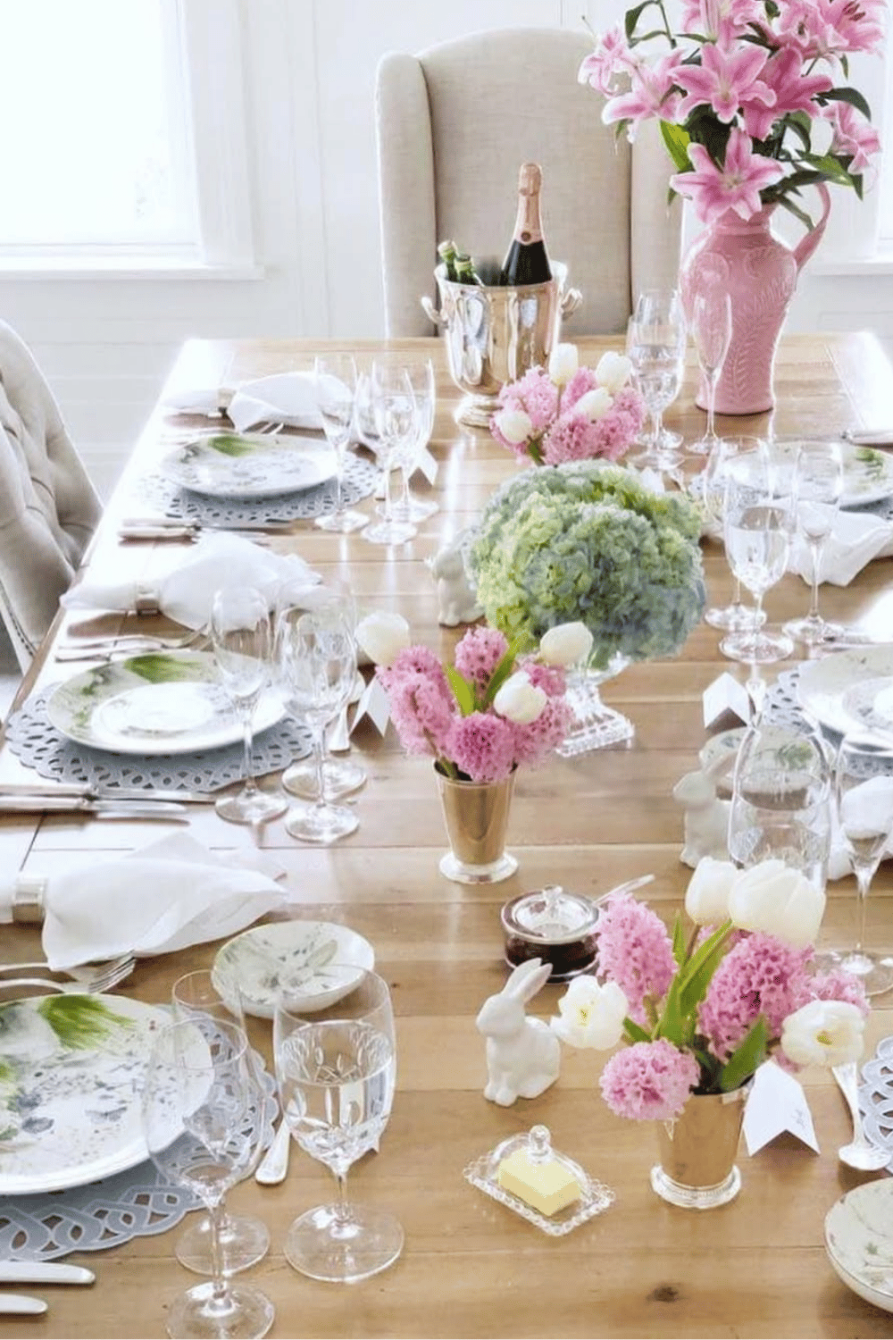Blush botanical Easter table ideas with soft pink flowers, gold-rimmed plates, and elegant Easter Table Decorations.