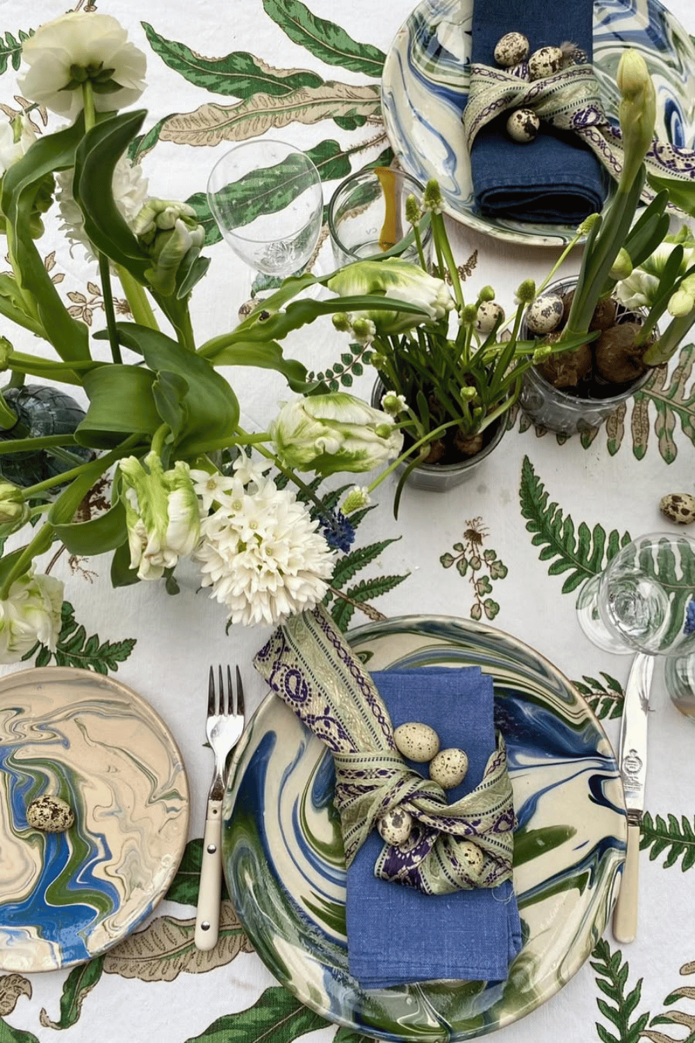 Botanical-inspired Easter Tablescape featuring fern-printed plates, deep blue linens, and fresh greenery.