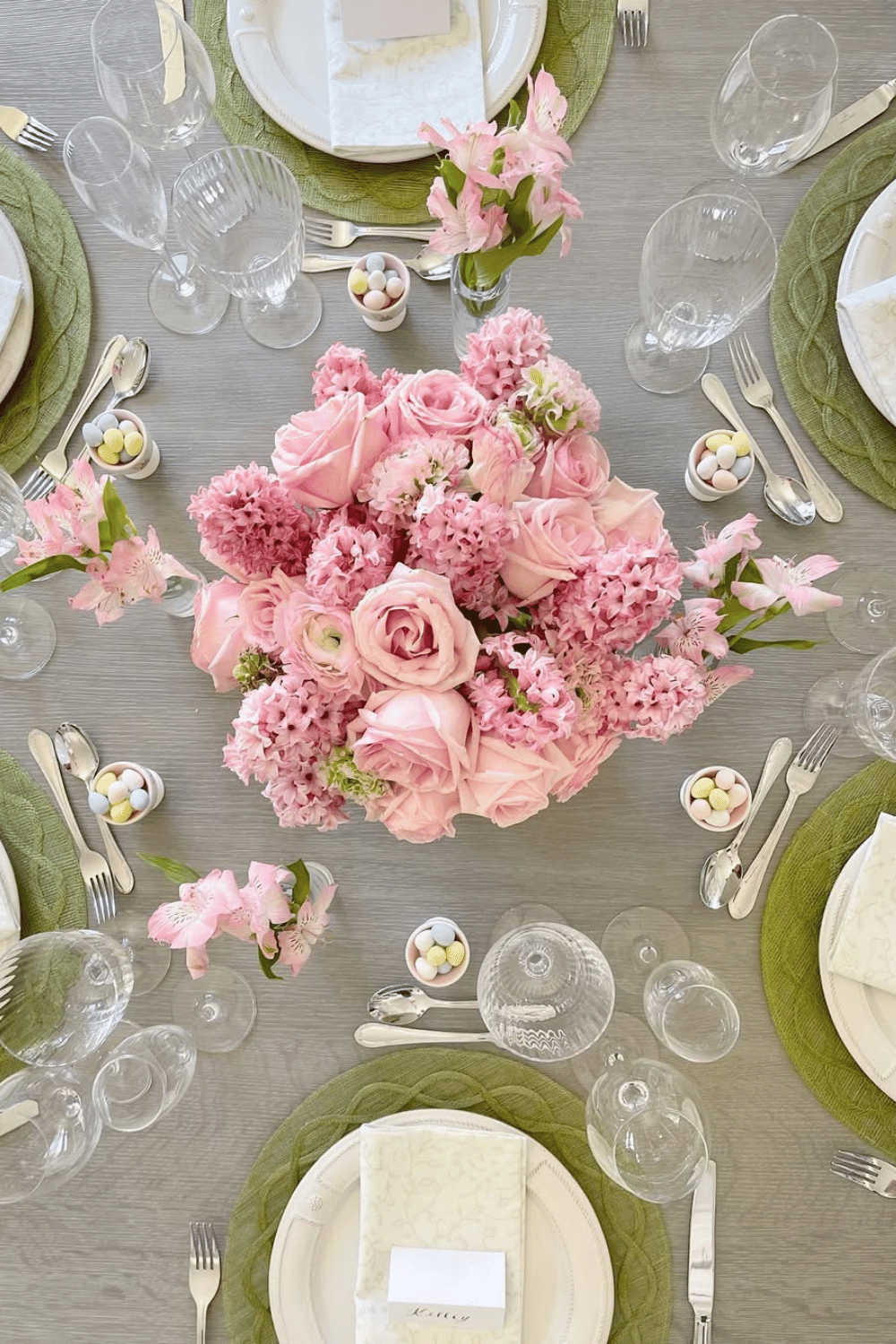 Sophisticated blush pink Easter dinner table with lush roses, soft greenery, and a delicate tablescape.