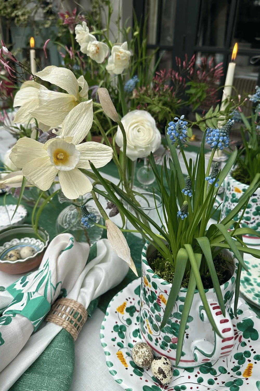 Vintage tea party-inspired Easter Table Decorations featuring floral teacups, speckled quail eggs, and dainty pastel accents.