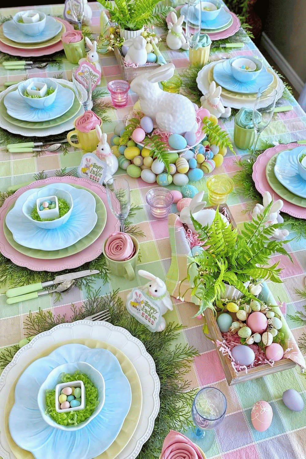Pastel-perfect Easter dinner table setting with layered ruffled plates, floral napkins, and ceramic Easter Bunny accents.