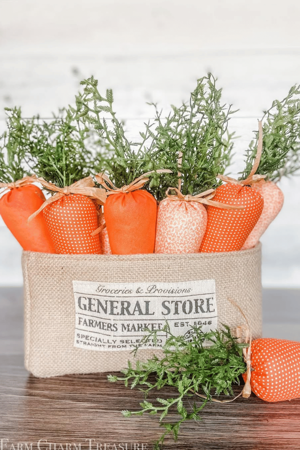 Farmhouse-style fabric carrots in a burlap bag.