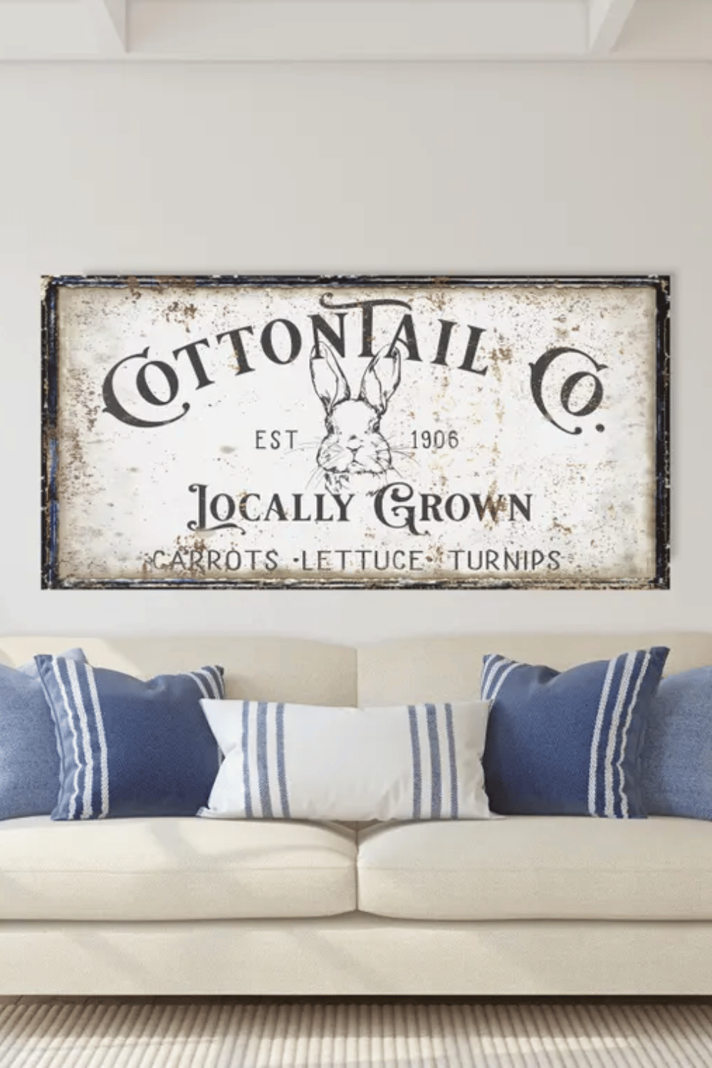 Vintage Cottontail Co. Easter sign above a cozy blue and white couch.