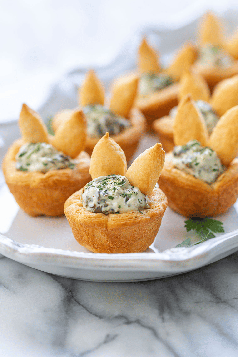 No Easter celebration is complete without these adorable bunny tartlets filled with creamy spinach dip. an easy and festive Easter appetizer!