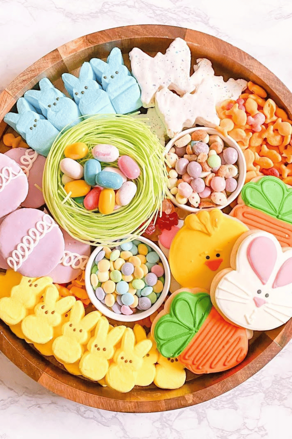 Create a fun Easter charcuterie board packed with pastel candies, Peeps, and cookies