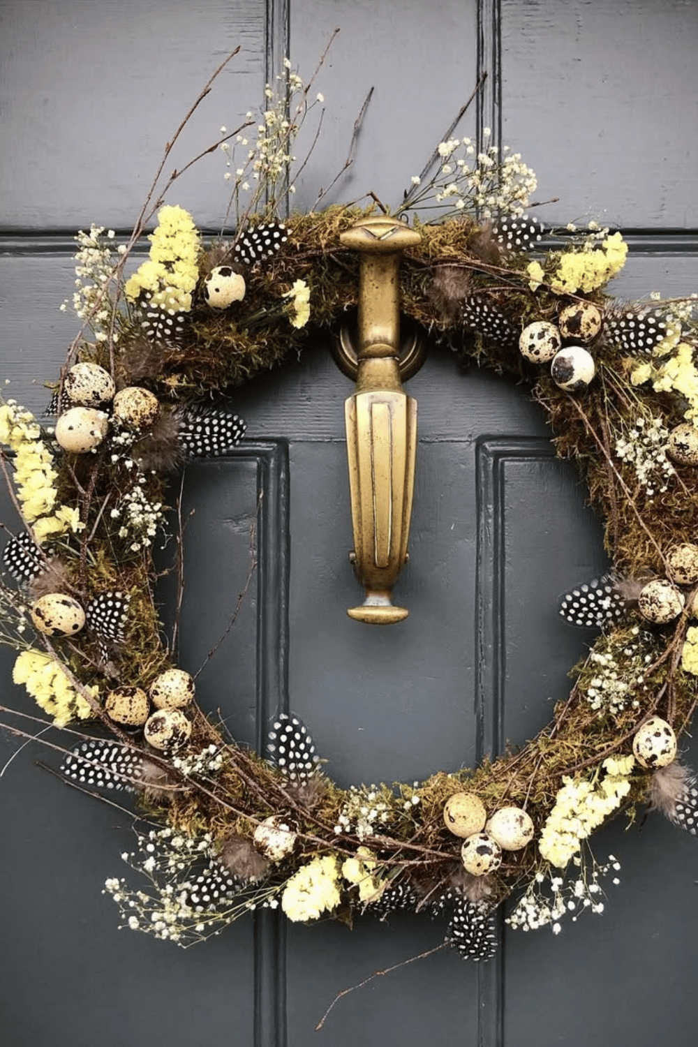 Easter wreath combines rustic feathers and speckled eggs with dried floral elements.