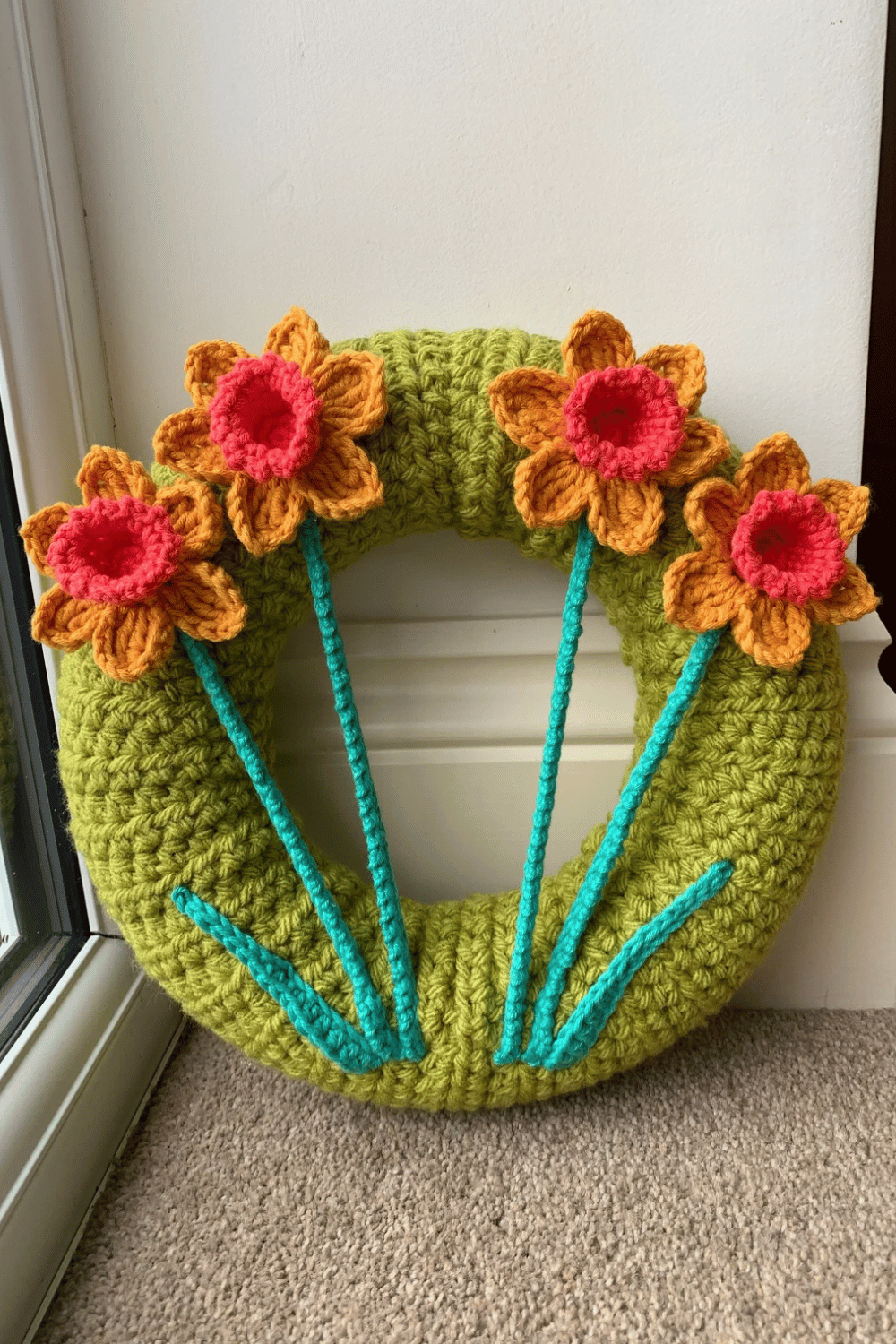 Hand-crocheted Easter wreath with daffodils.