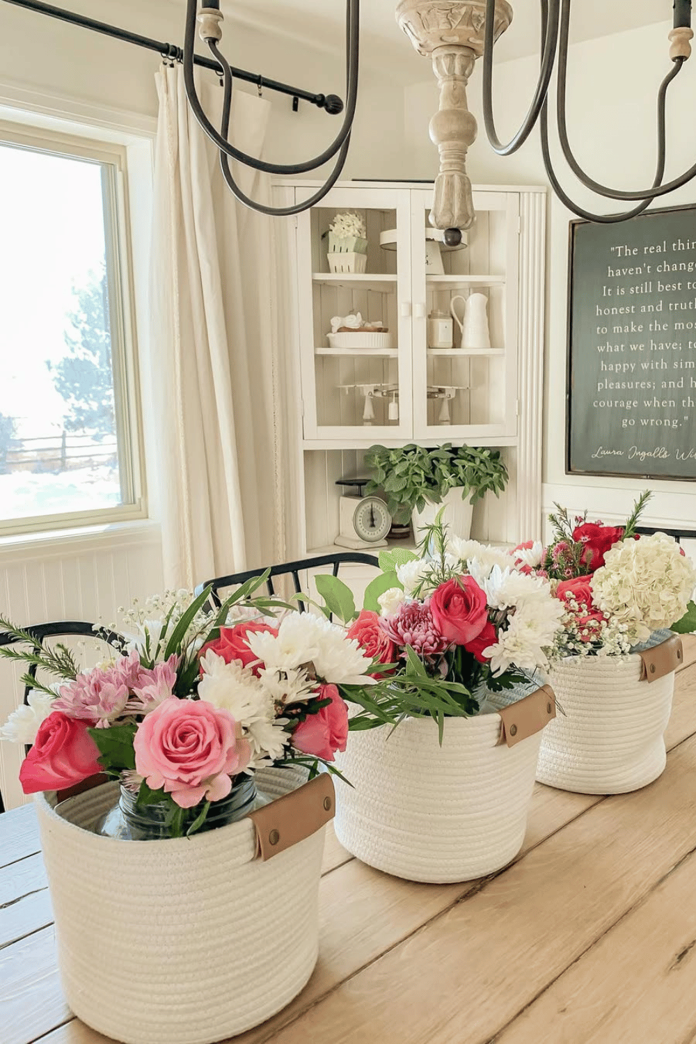 Fresh spring flowers arranged in white rope baskets as a dining table centerpiece