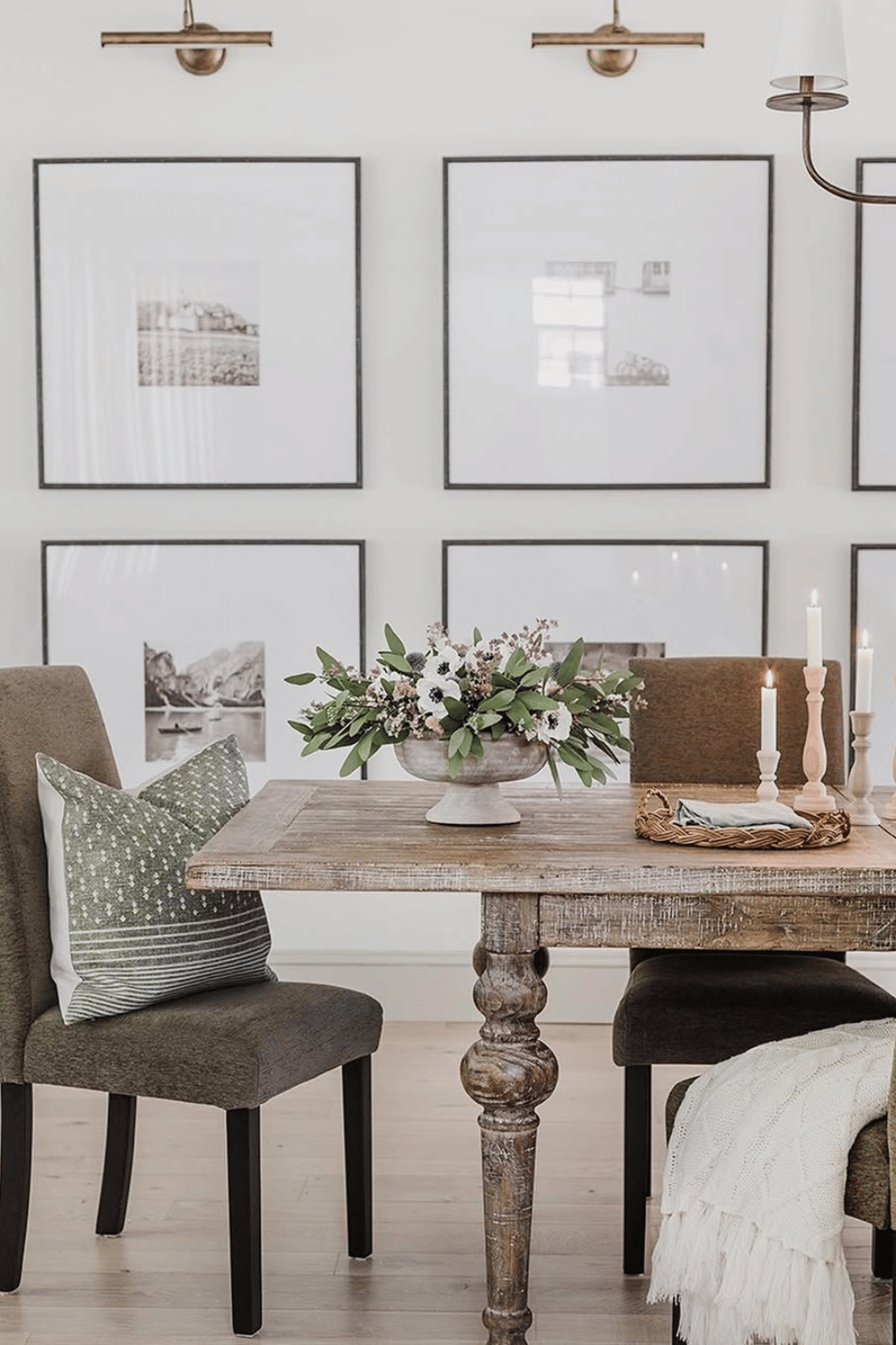 Neutral floral compote arrangement with greenery and white flowers on rustic dining table