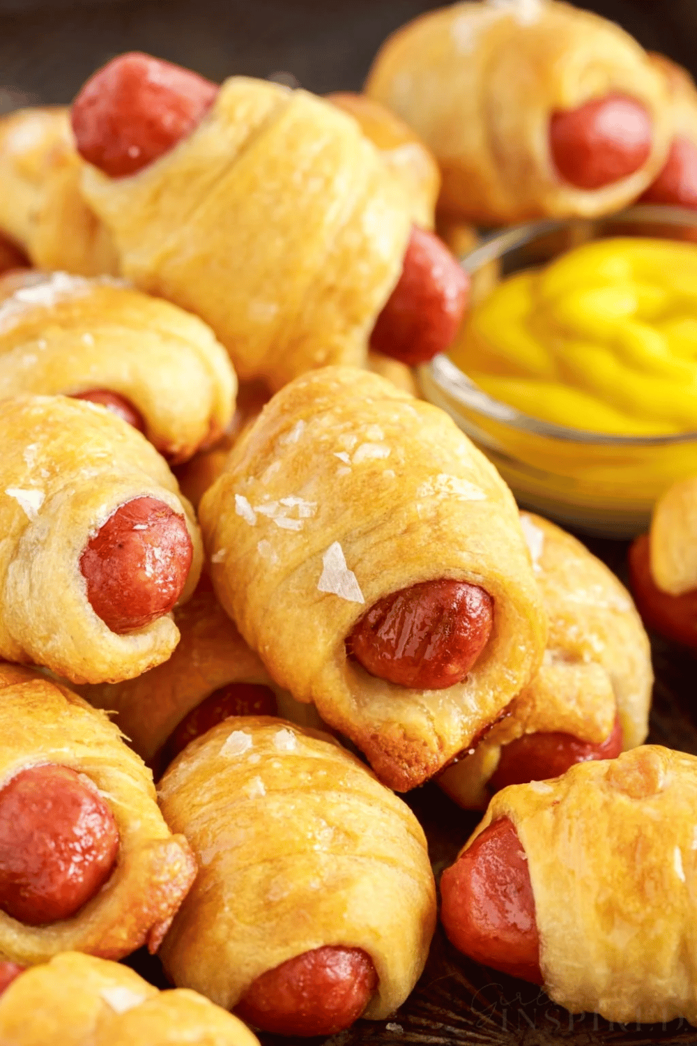Golden brown crescent roll Lil Smokies served with mustard dipping sauce