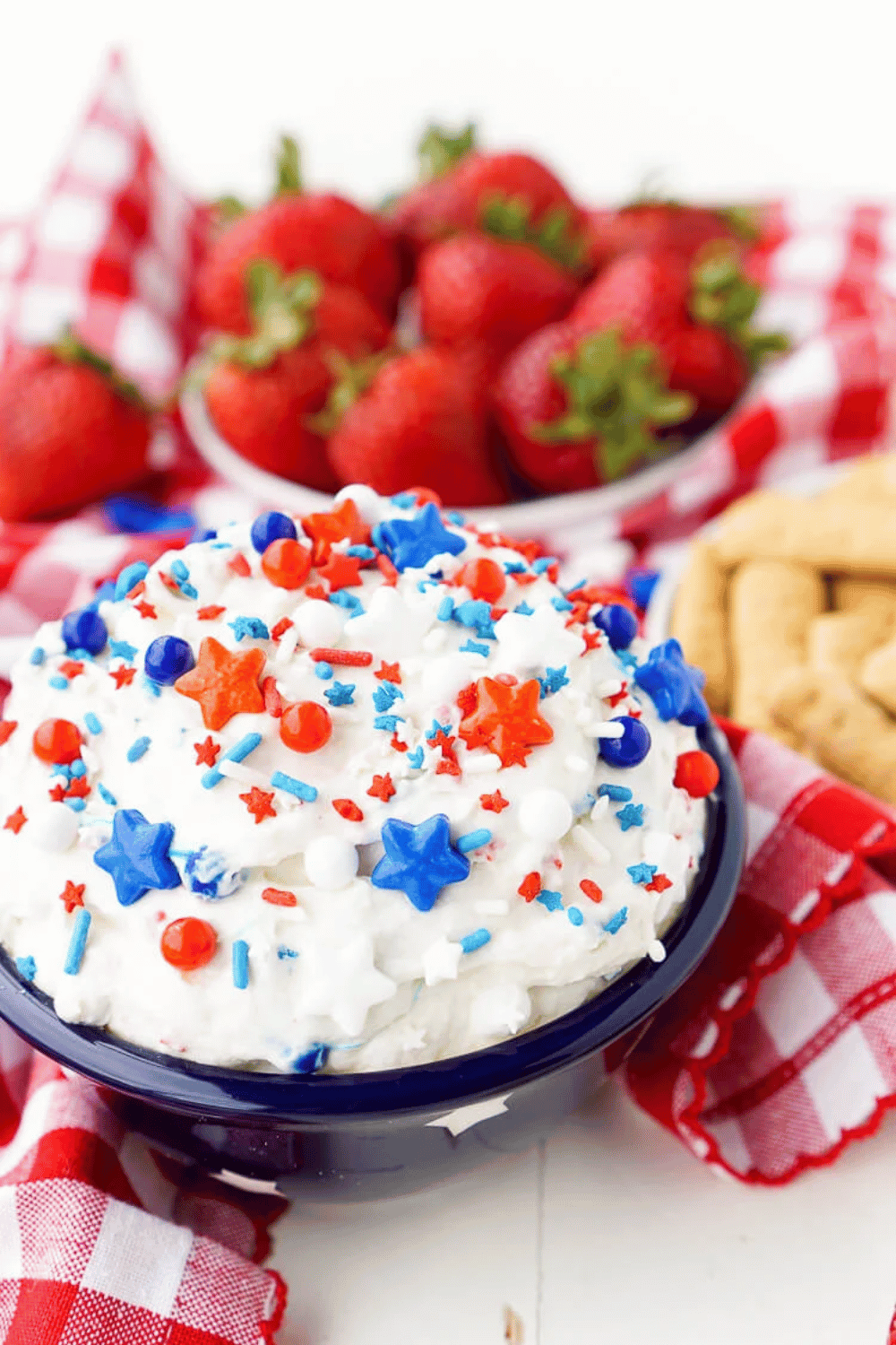 Cake batter dip with red, white, and blue sprinkles and fresh strawberries