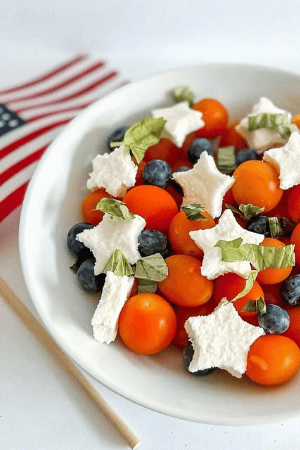 Red, white, and blue Caprese salad with blueberries, cherry tomatoes, and mozzarella stars