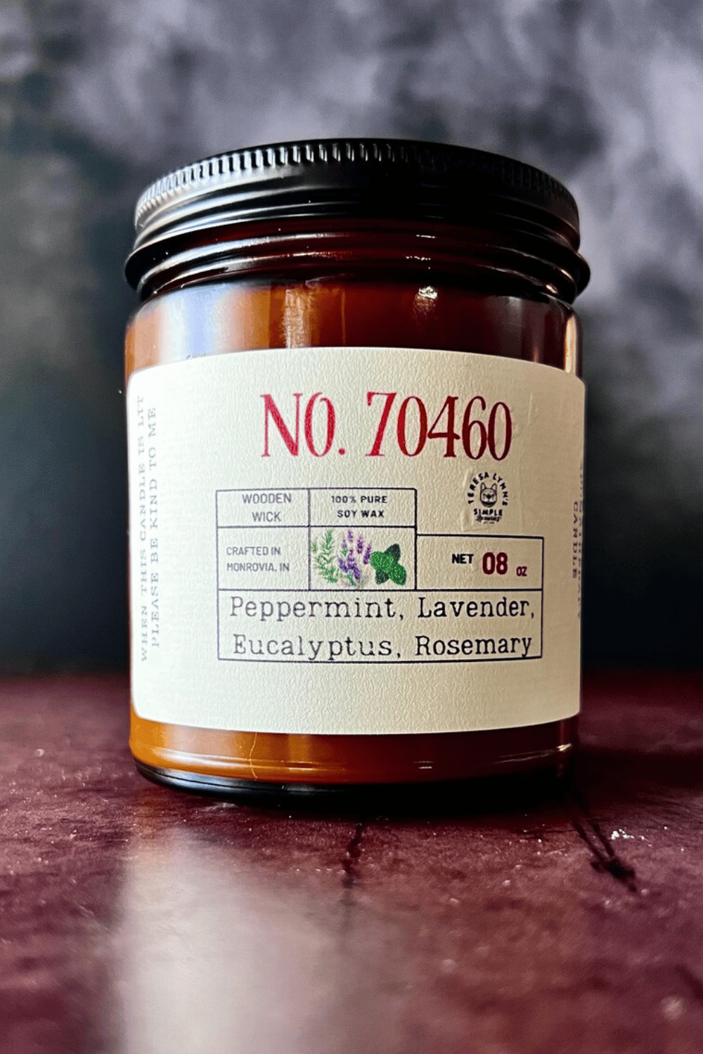 Homemade peppermint and lavender soy candles in glass jars on a cozy table