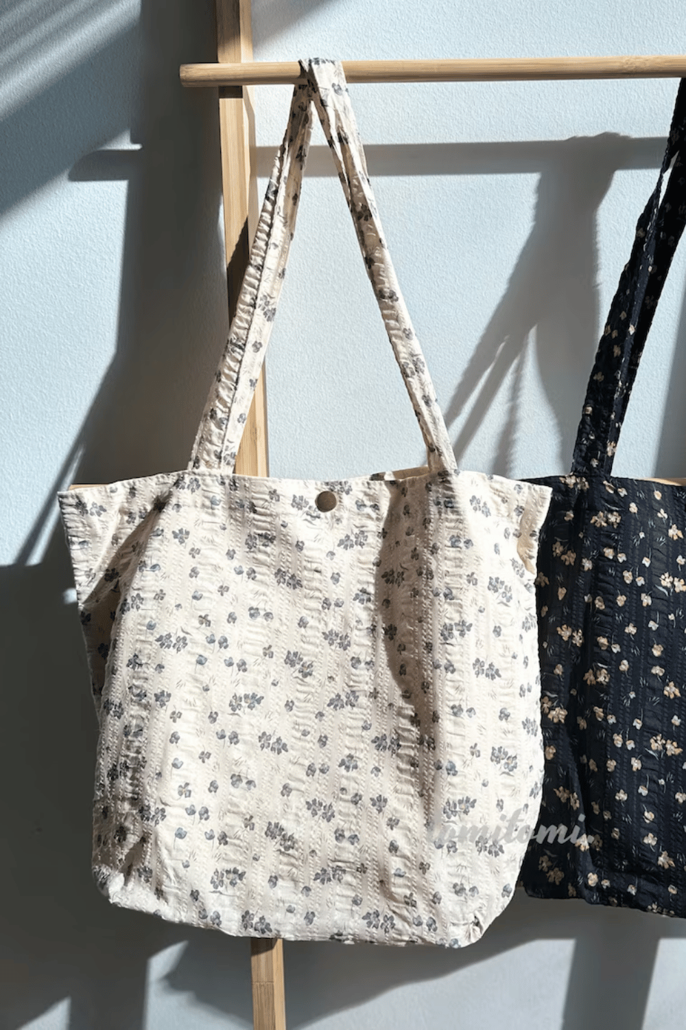 Floral printed tote bag hanging on a door hook