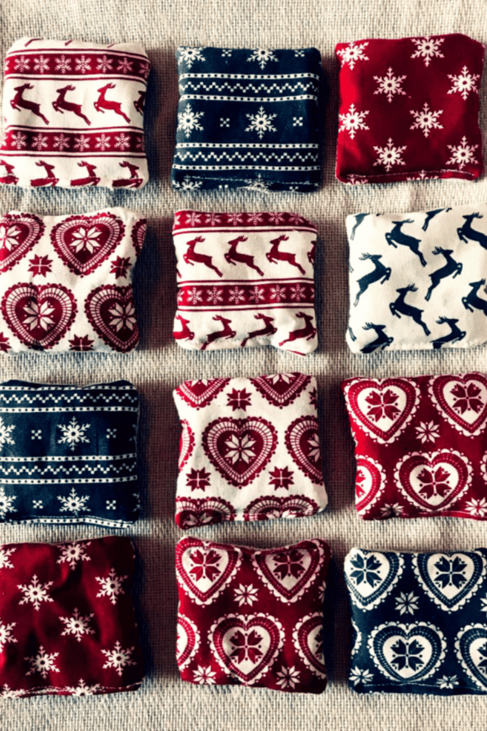 Fabric hand warmers with cozy winter patterns on a table