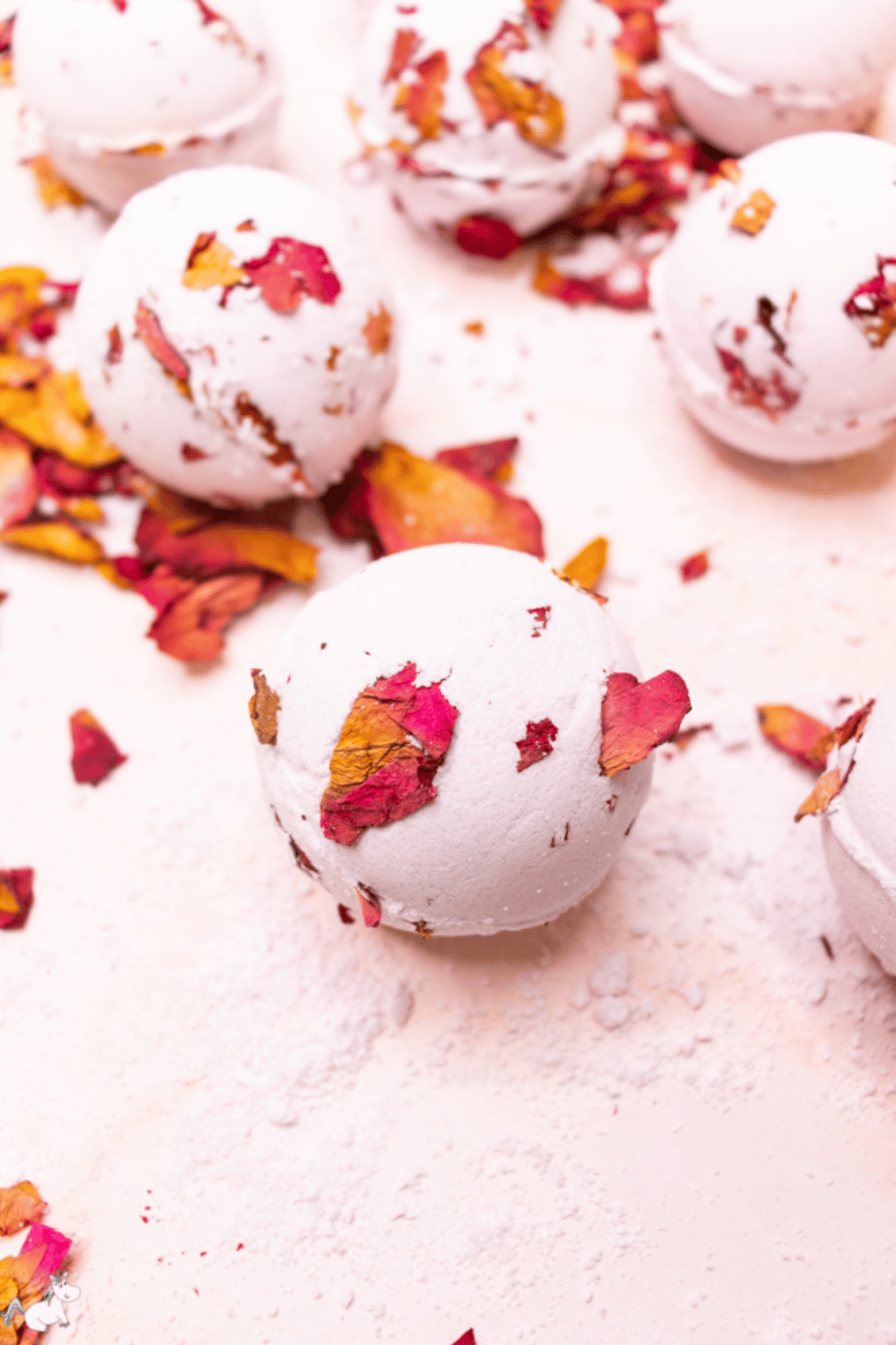 Handmade rose bath bombs with dried petals and soft color
