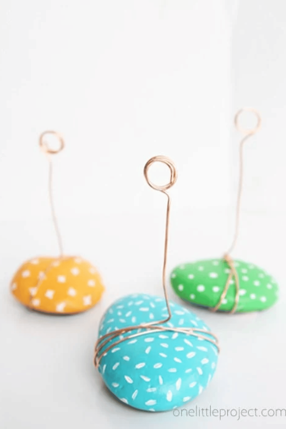 Rock photo holders with wire clips holding mini prints