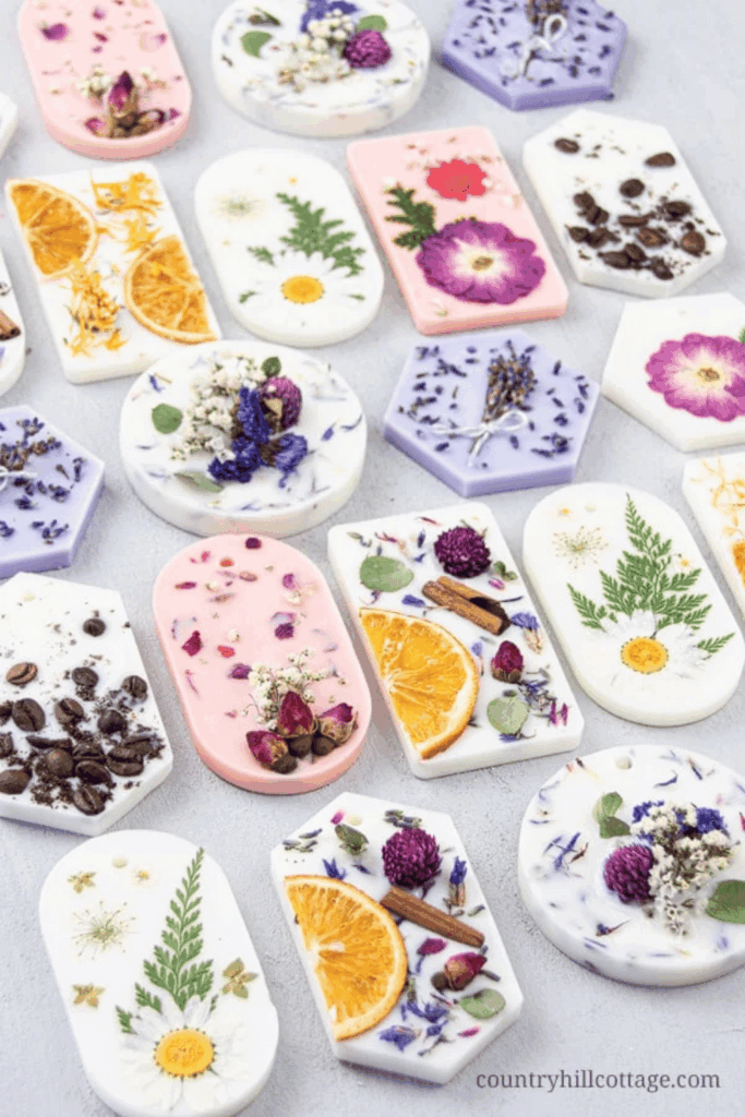 Flat lay of handmade wax melts and botanical candles with dried flowers and fruit