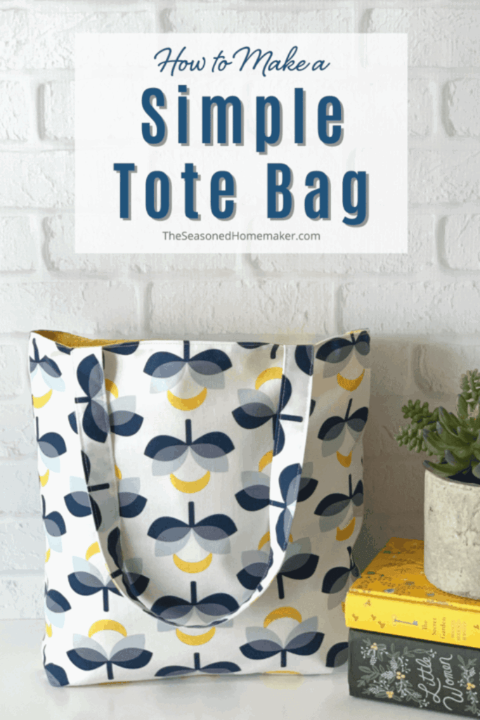 Modern patterned tote bag standing upright against a white brick wall