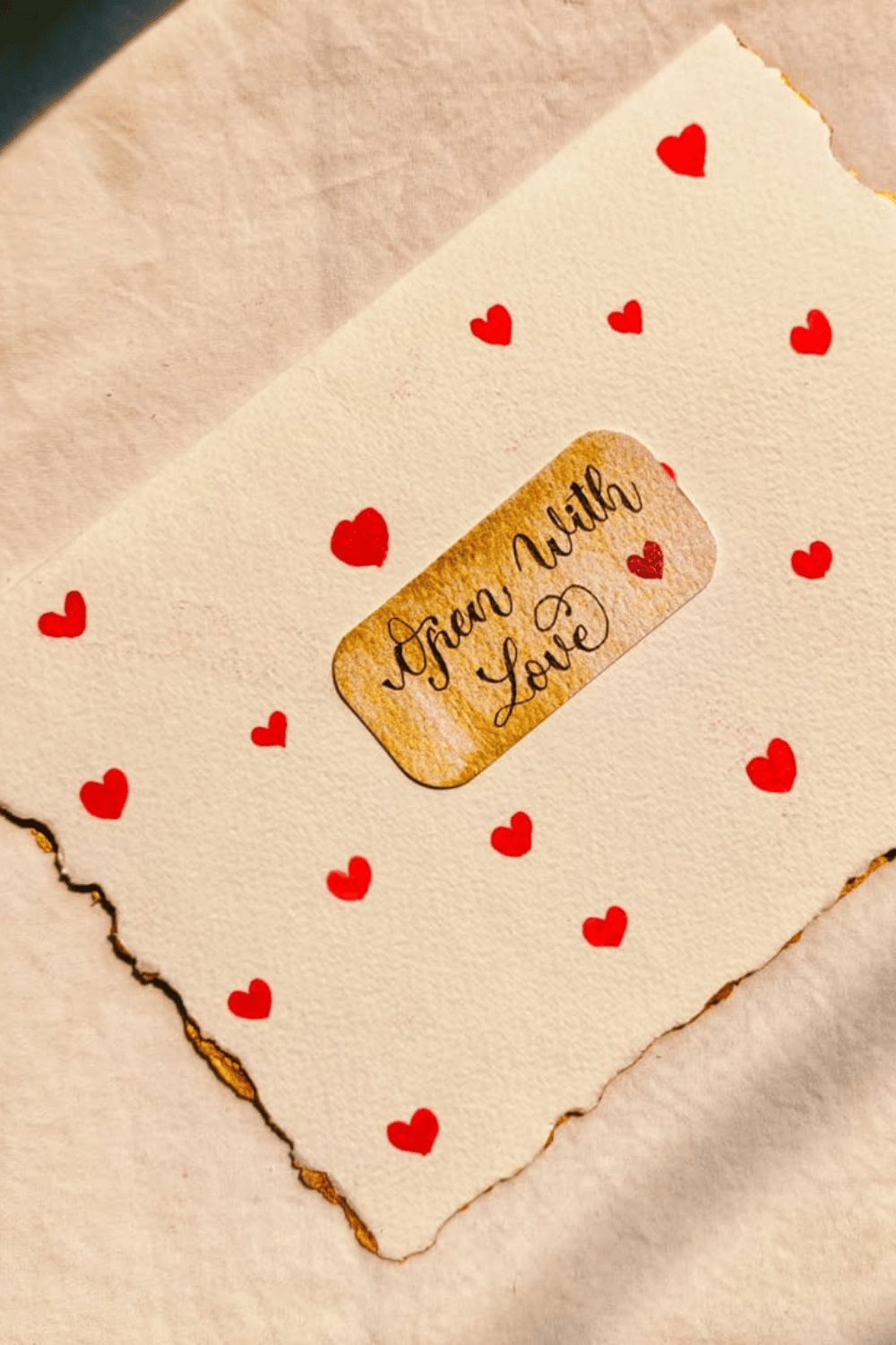 Handmade card with red hearts and “Open With Love” label