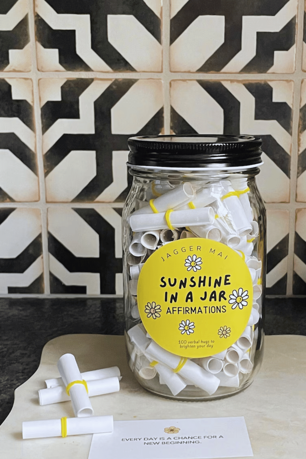 “Sunshine in a Jar” filled with rolled paper affirmations and yellow label