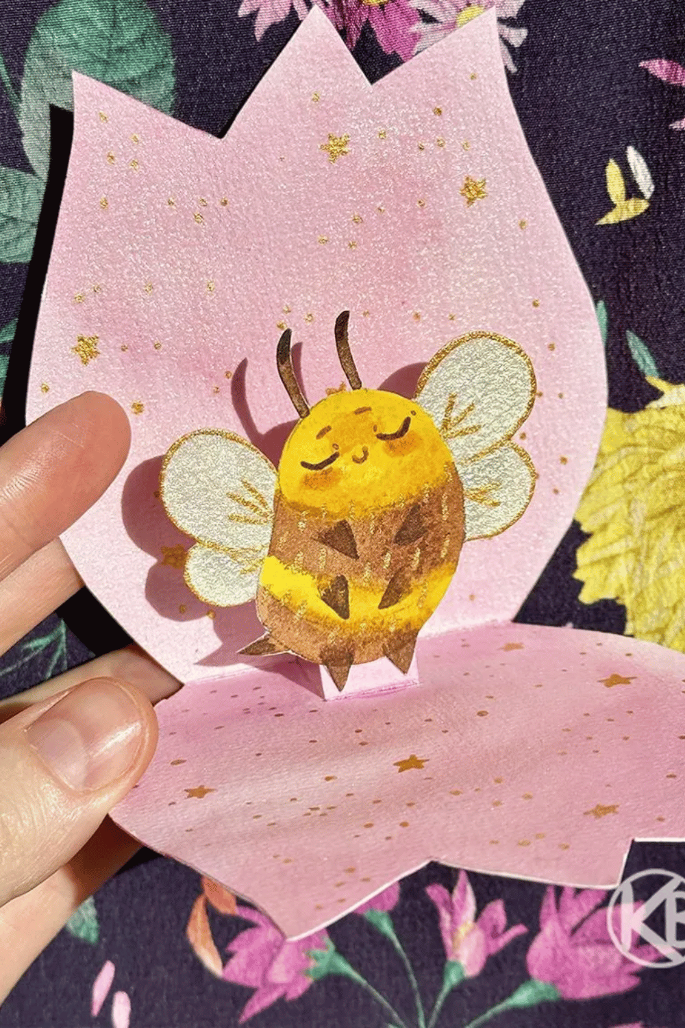 Cute handmade pop-up card with a smiling bee inside a flower shape
