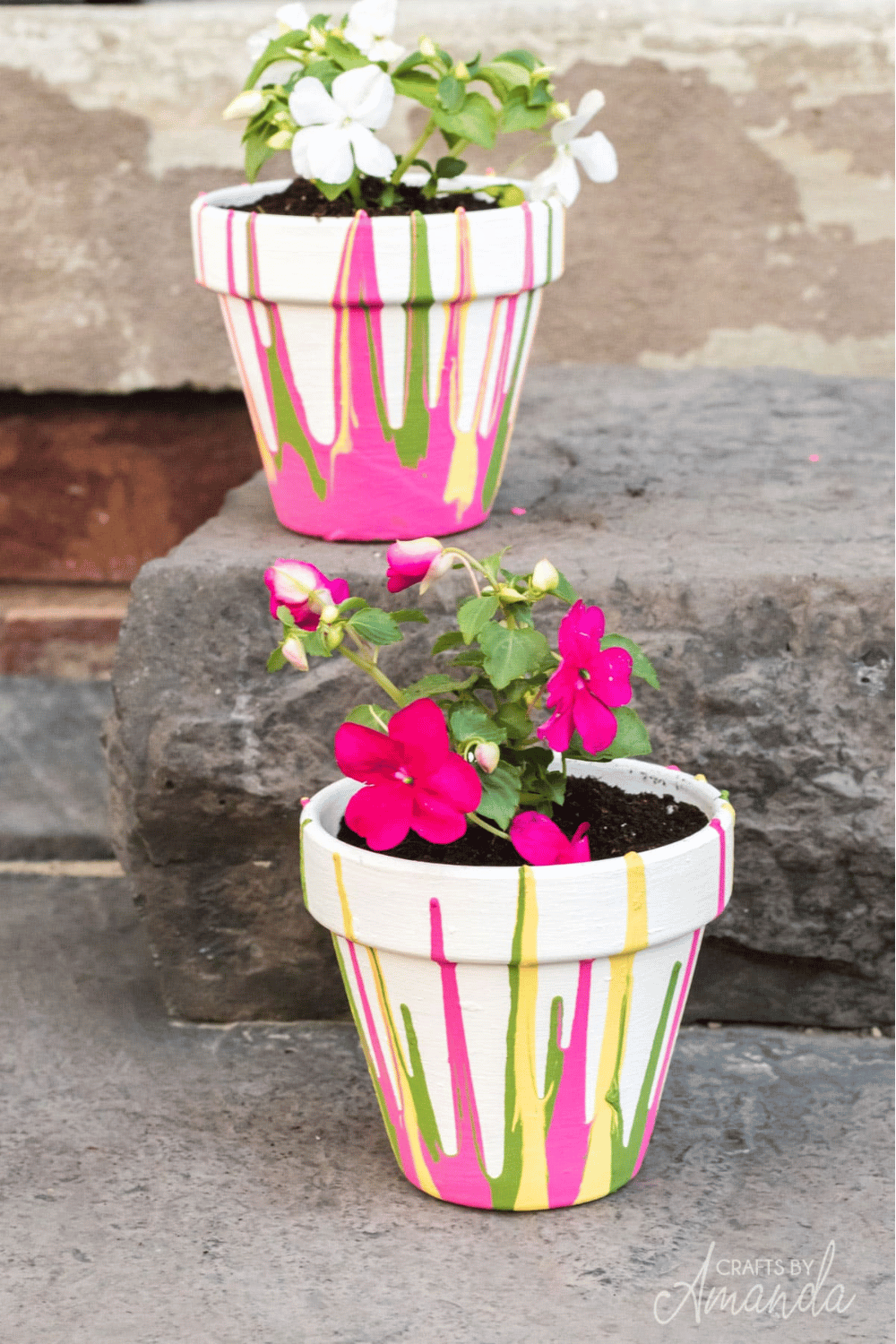 Hand-painted flower pots with neon pink, green, and yellow paint drips