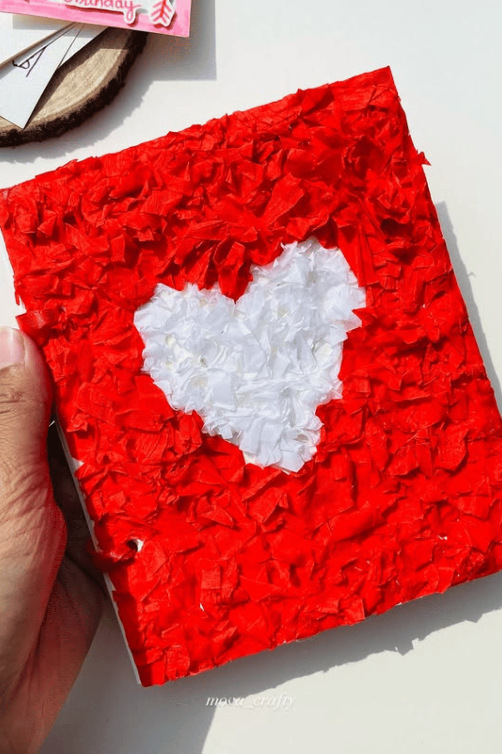 Handmade tissue paper heart scrapbook in red and white with crinkled texture