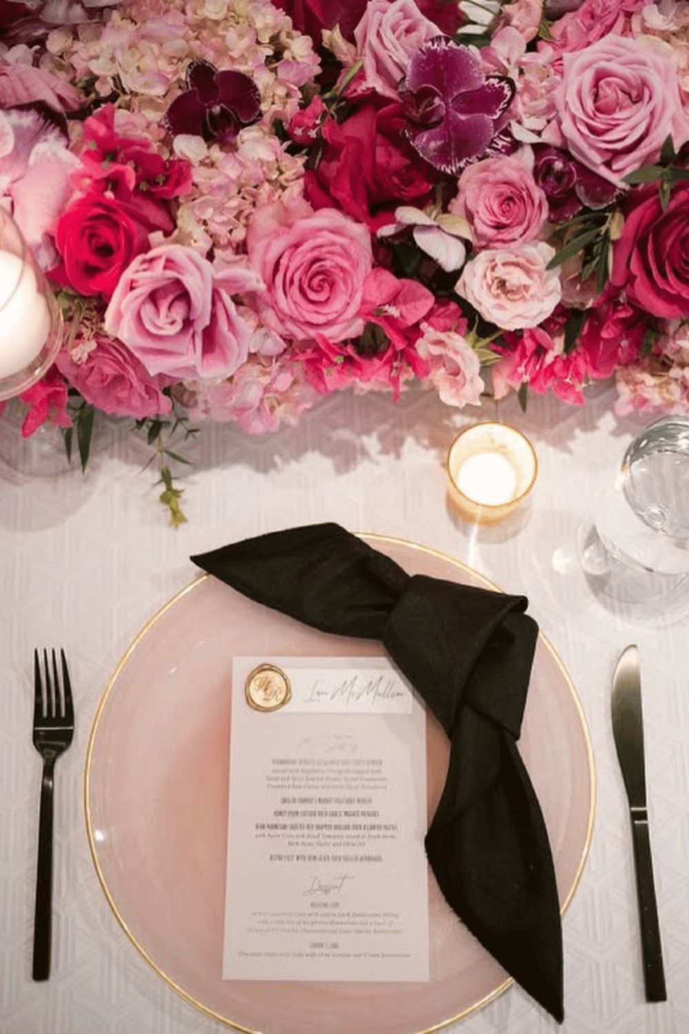 Modern pink and black wedding table with bold rose floral runner