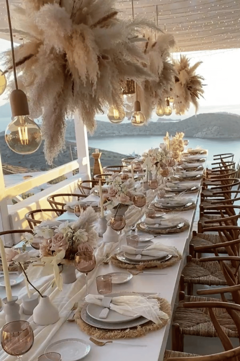 Boho neutral wedding table with pampas chandeliers and woven chargers