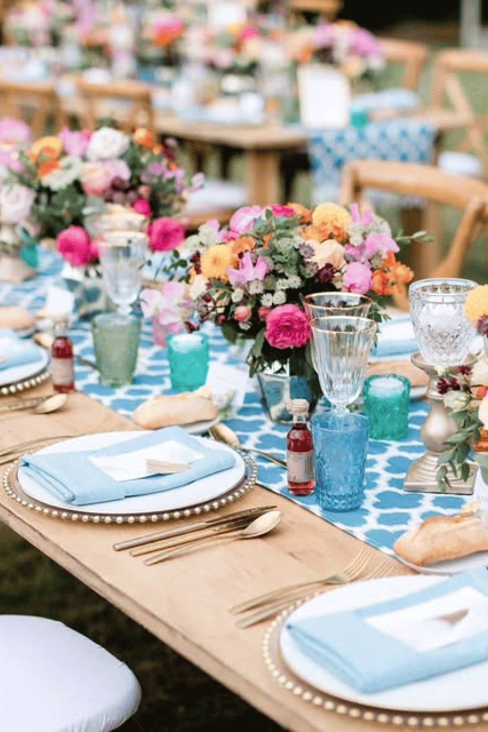 Bright blue and pink table setting with bold linens and cheerful florals