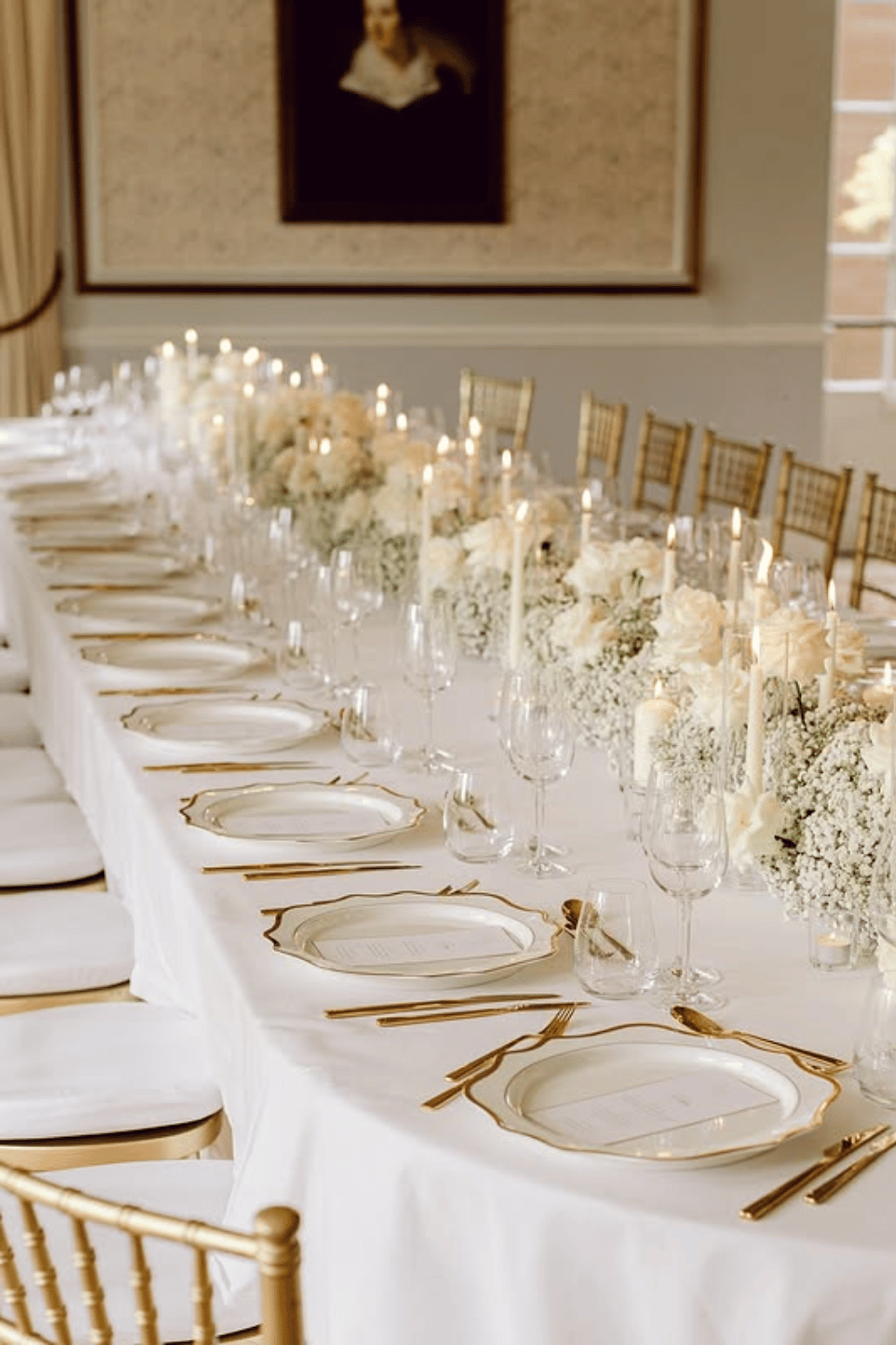 Elegant white and gold table setup with roses and baby's breath florals